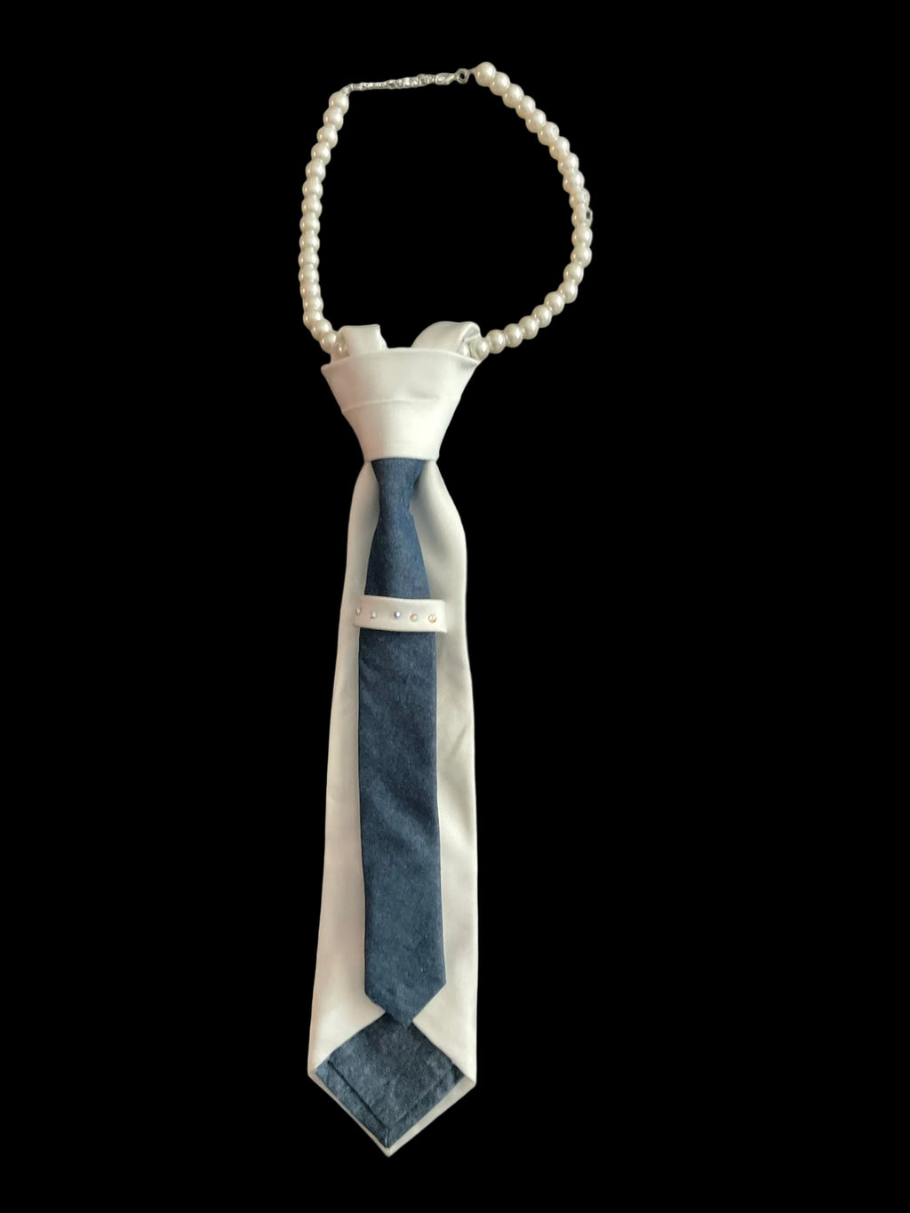 White dress with a blue tie and pearl necklace on a white background